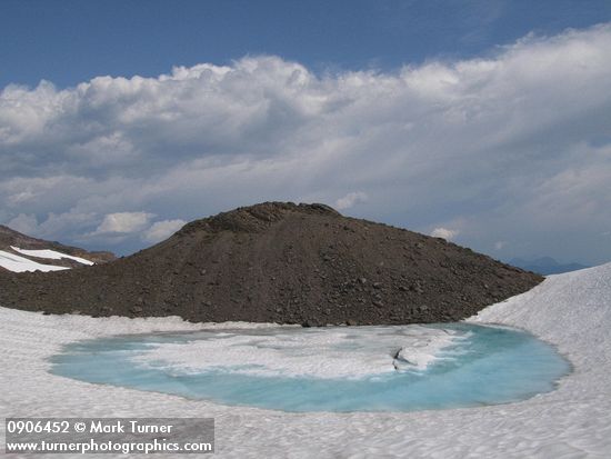 Snowmelt pool at base of glacial moraine